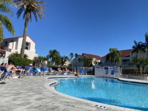 Vista Verde East community swimming pool surrounded by palm trees on Isla Del Sol